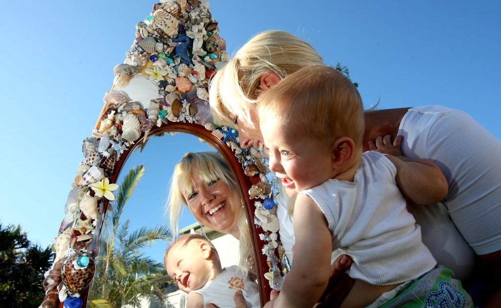 Artist Belinda Endler and son Frankie Capps with her surfboard mirror. Artist Belinda Endler and son Frankie Capps with her surfboard mirror.