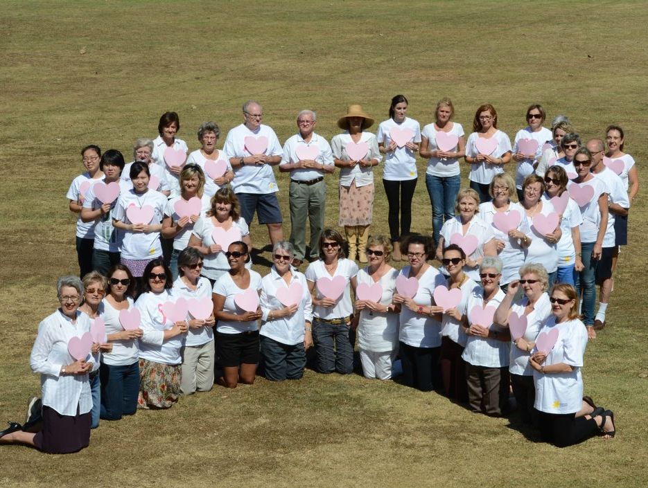 Local women and supporters gathered at Geogg Watt oval to form the shape of a pink ribbon. Local women and supporters gathered at Geogg Watt oval to form the shape of a pink ribbon.
