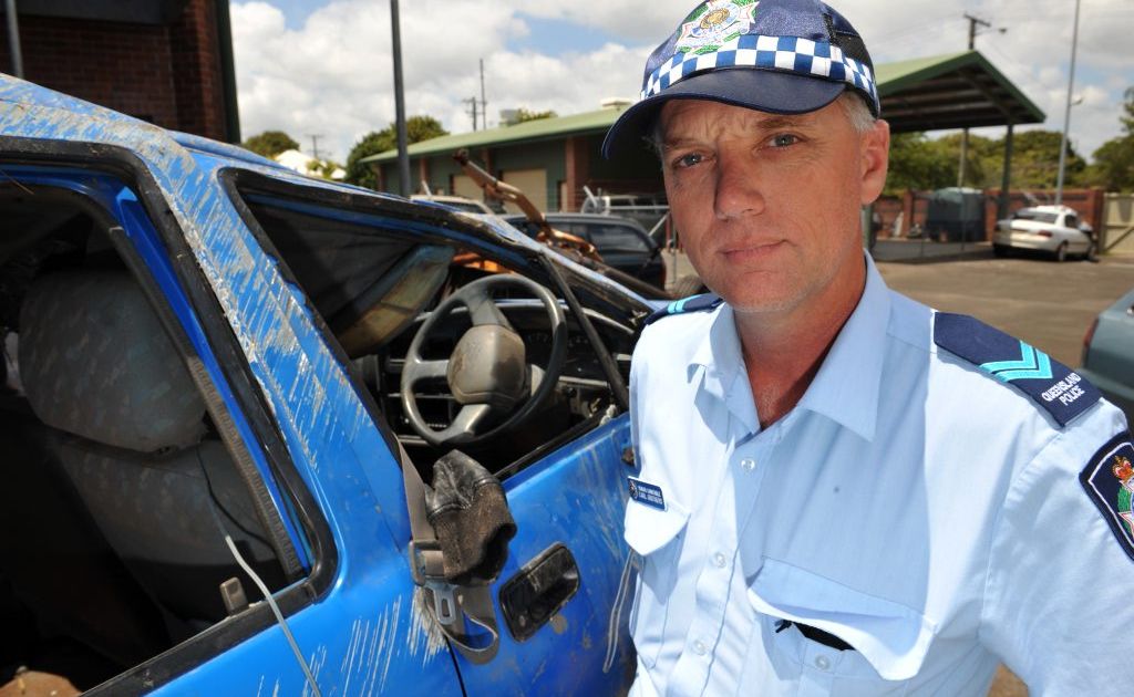 FATAL CRASH: Snr Const Carl Grotaers with the wreckage of the car in which a 20-year-old man was killed when it crashed on Dr Mays Crossing Road.
FATAL CRASH: Snr Const Carl Grotaers with the wreckage of the car in which a 20-year-old man was killed when it crashed on Dr Mays Crossing Road.