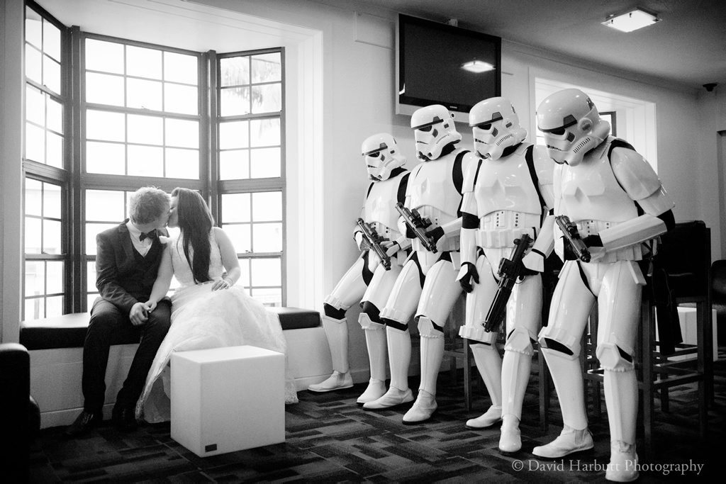 The happy couple share a special moment as their stormtrooper bridal party look on. Photo: David Harbutt Photography. The happy couple share a special moment as their stormtrooper bridal party look on. Photo: David Harbutt Photography.