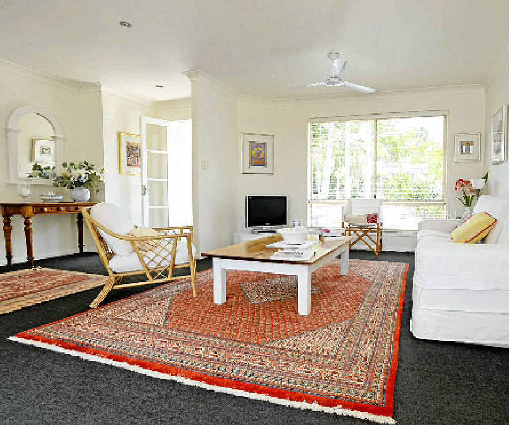 The sitting room is a light-filled, predominantly white space with colourful rugs and soft furnishings. Gowan allows a house to transform over time. The sitting room is a light-filled, predominantly white space with colourful rugs and soft furnishings. Gowan allows a house to transform over time.