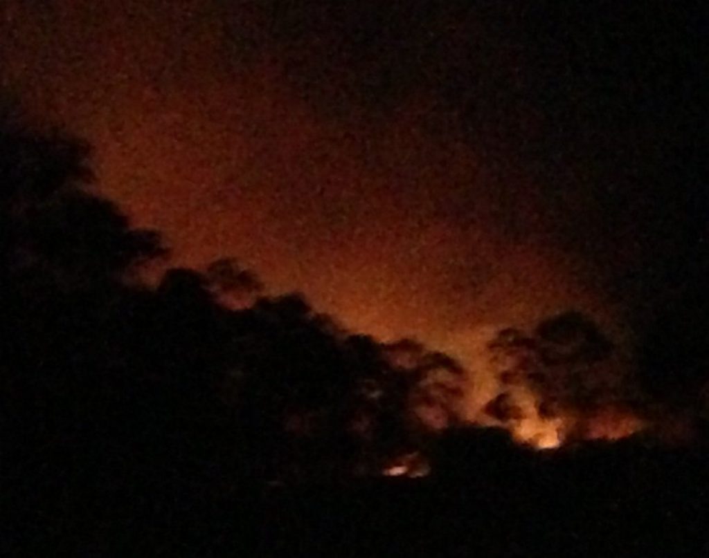 This photo by Naomi Booth, Burua, shows the glow from the Beecher fire. This photo by Naomi Booth, Burua, shows the glow from the Beecher fire.