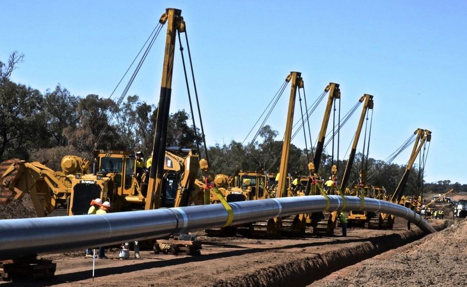 Australia Pacific LNG's main transmission pipeline going into the ground. Australia Pacific LNG's main transmission pipeline going into the ground.