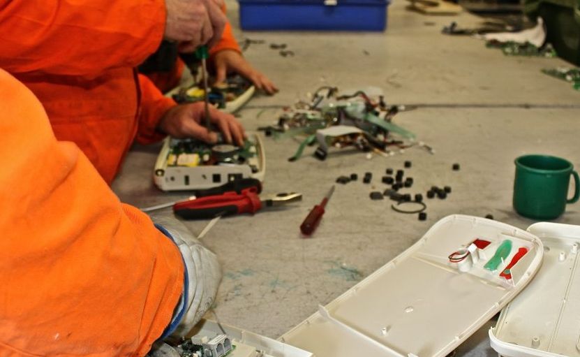 Prisoners salvage parts from e-waste. Prisoners salvage parts from e-waste.