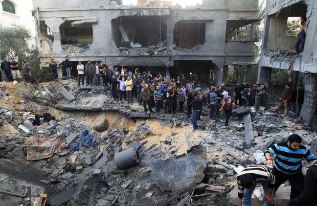 Palestinians gather around a destroyed home of the al-Dallu family following an Israeli air strike in Gaza City, on November 18, 2012. At least seven members of the same family, including four children, were among nine people killed when an Israeli missile struck a family home in Gaza City, the health ministry said GETTY IMAGES Palestinians gather around a destroyed home of the al-Dallu family following an Israeli air strike in Gaza City, on November 18, 2012. At least seven members of the same family, including four children, were among nine people killed when an Israeli missile struck a family home in Gaza City, the health ministry said GETTY IMAGES