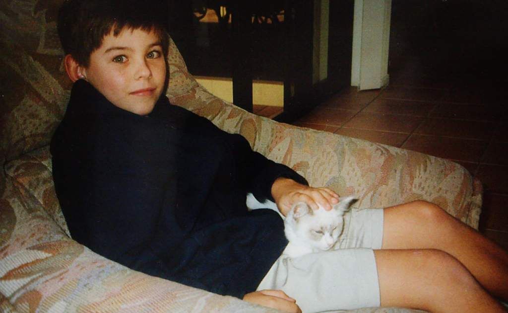 Daniel with the family cat. Daniel with the family cat.