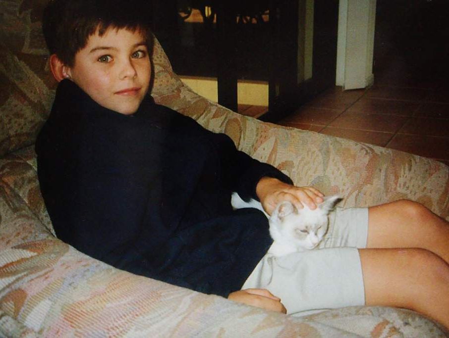 Daniel with the family cat. Daniel with the family cat.