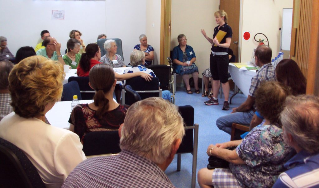 LEARNING: The group listens intently to how to prevent falls at home. LEARNING: The group listens intently to how to prevent falls at home.