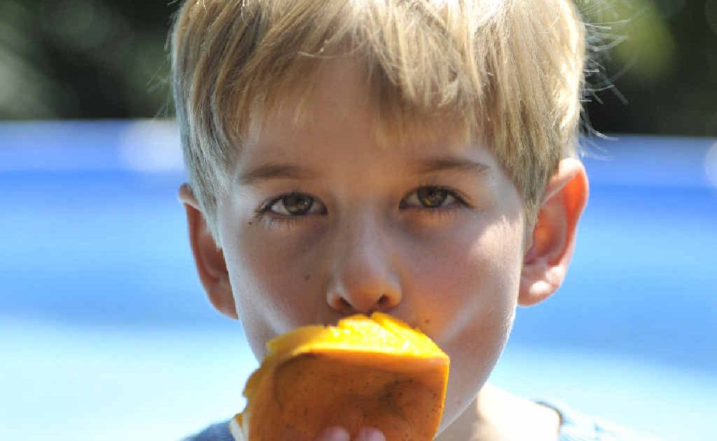 Finn Campbell eating a refreshing mango. Finn Campbell eating a refreshing mango.