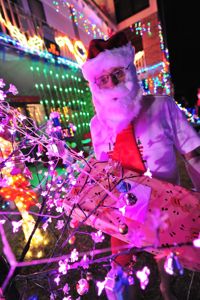 Alick Robinson from Coolum puts on a huge Christmas light show and dresses as Santa to give gifts away to children. Photo:Iain Curry / Sunshine Coast Daily