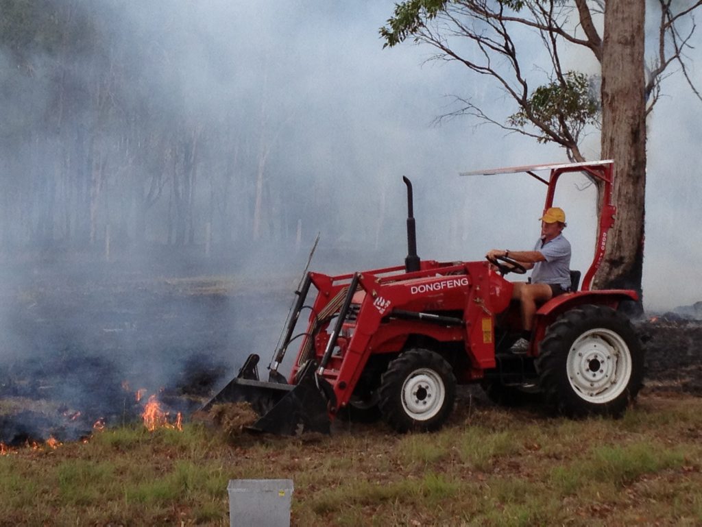Local resident Trevor Davidson uses his tractor to help fight the fire at Sunshine Acres. Local resident Trevor Davidson uses his tractor to help fight the fire at Sunshine Acres.
