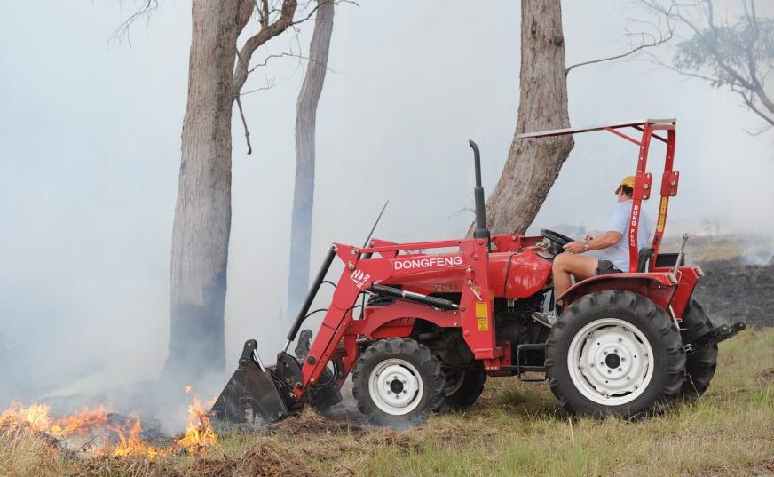 Land owner Trevor Davidson creating a firebreak behind houses in Karinya Circuit at Sunshine Acres. Land owner Trevor Davidson creating a firebreak behind houses in Karinya Circuit at Sunshine Acres.