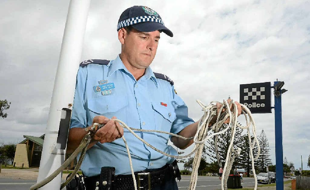 FLAG STOLEN: Senior Constable Mick Kelly with the rope which normally holds the flag aloft at Kingscliff police station. FLAG STOLEN: Senior Constable Mick Kelly with the rope which normally holds the flag aloft at Kingscliff police station.