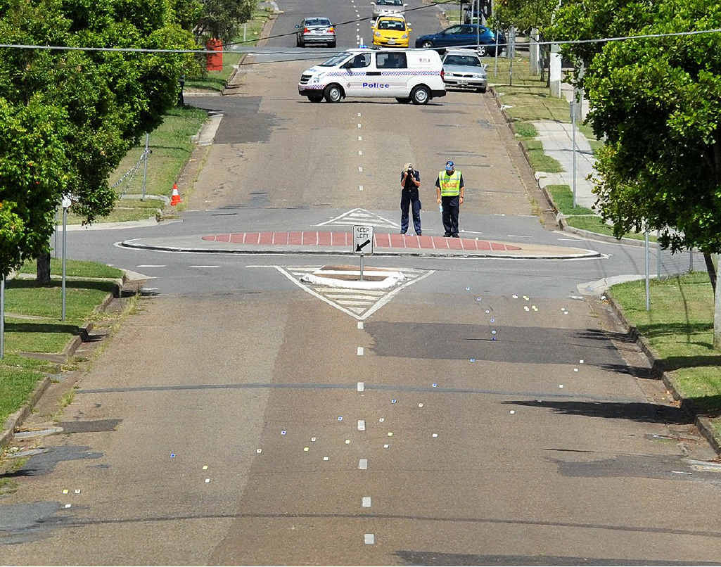 Police forensics officers collect information at the fatal crash site. Police forensics officers collect information at the fatal crash site.