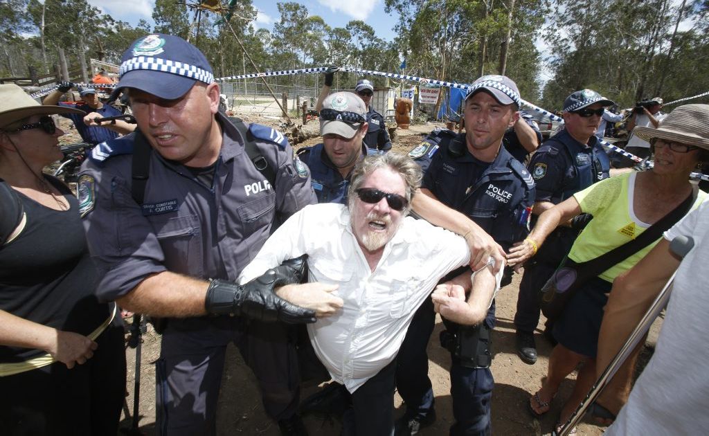 A man is forced out of the line by police as they move people back along the avenue as the road is closed around the Glenugie CSG site. Photo Adam Hourigan / The Daily Examiner A man is forced out of the line by police as they move people back along the avenue as the road is closed around the Glenugie CSG site. Photo Adam Hourigan / The Daily Examiner