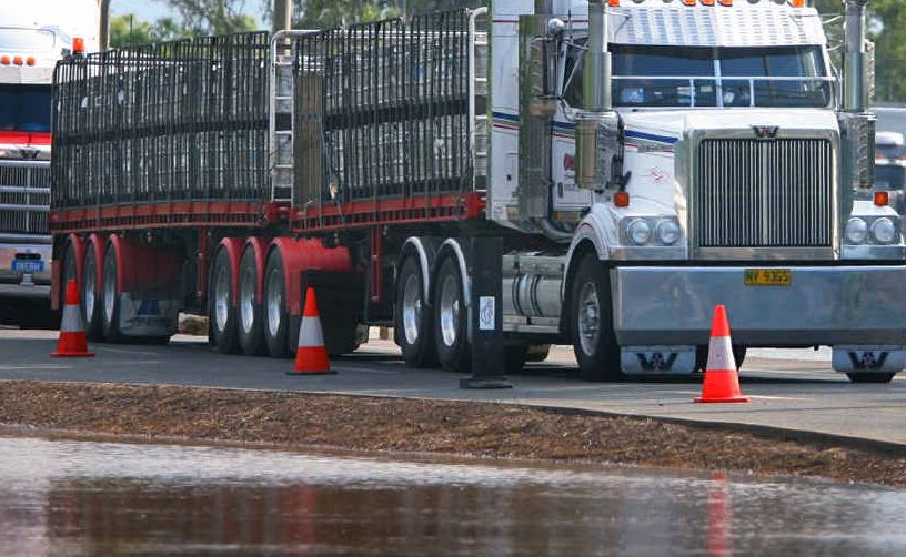 GREEN LIGHT: Trucks finally roll into Rockhampton in 2011 as floodwaters recede and the Bruce Highway reopens after two weeks . GREEN LIGHT: Trucks finally roll into Rockhampton in 2011 as floodwaters recede and the Bruce Highway reopens after two weeks .