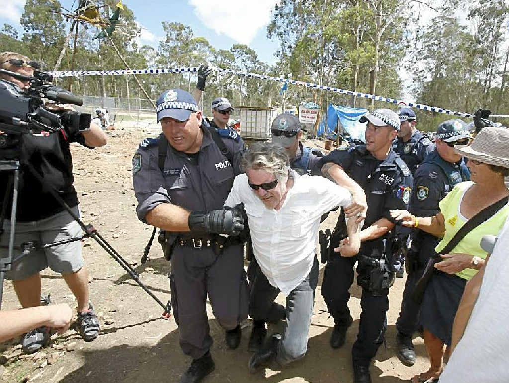 A man is forced out of the line by police as they move people back along The Avenue as the road is closed around the Glenugie CSG site. A man is forced out of the line by police as they move people back along The Avenue as the road is closed around the Glenugie CSG site.
