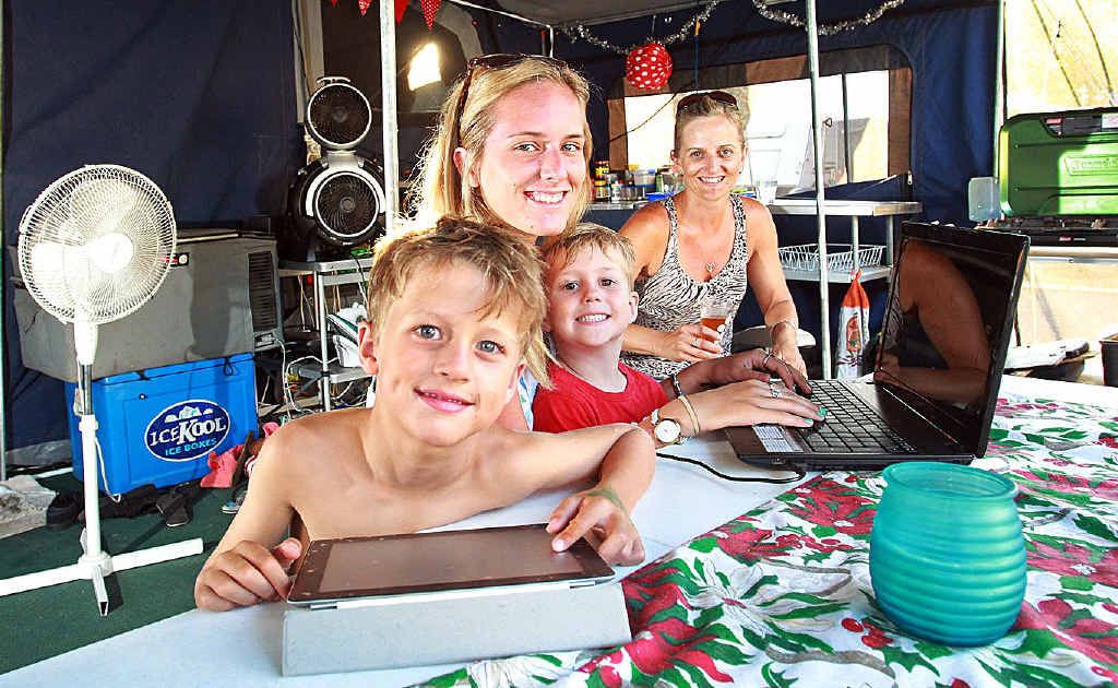 Glam campers (from left) George Gillan, Jacob Kidd, Carlee Foxwell and Mel Foxwell with all their mod cons at Mooloolaba, including laptops, iPads, fridge, toilet, an iron and a pizza cooker. Glam campers (from left) George Gillan, Jacob Kidd, Carlee Foxwell and Mel Foxwell with all their mod cons at Mooloolaba, including laptops, iPads, fridge, toilet, an iron and a pizza cooker.