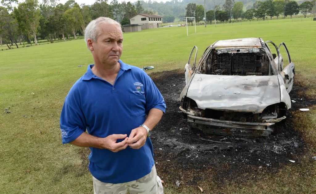 Paul Albertini president of the Lismore Thistles Soccer Club pictured on one of the playing fields and the burnt out car. Paul Albertini president of the Lismore Thistles Soccer Club pictured on one of the playing fields and the burnt out car.