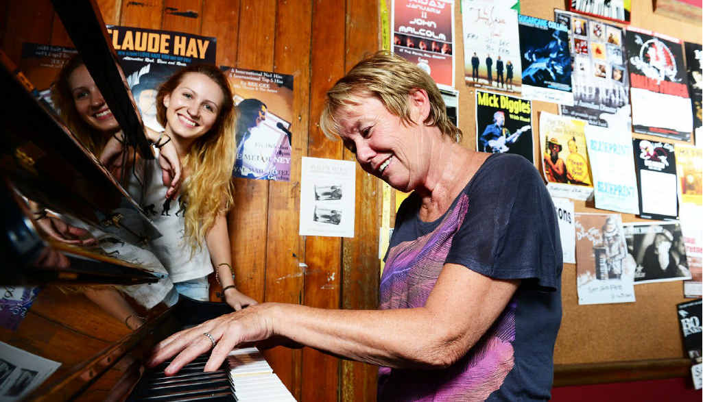 ON SONG: Blues musician Cath Butler, pictured with Addie Cafe of the Royal Mail Hotel, plays on the piano donated after the floods; (below) the Hard Rain album cover. ON SONG: Blues musician Cath Butler, pictured with Addie Cafe of the Royal Mail Hotel, plays on the piano donated after the floods; (below) the Hard Rain album cover.
