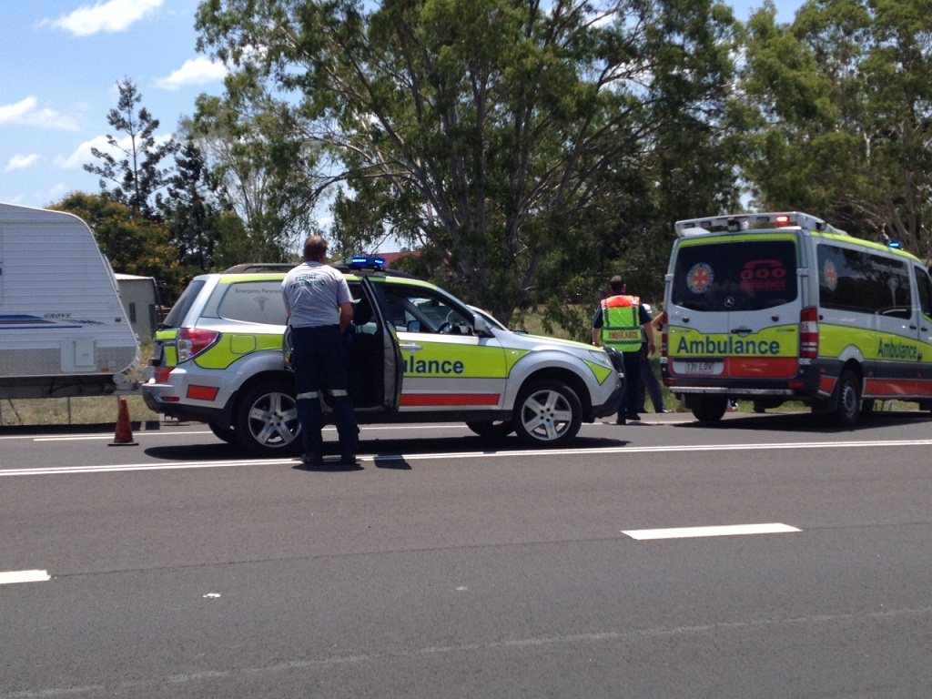 Ambulance officers are among the emergency service workers at the scene of a crash on the Bruce Hwy at Tiaro.