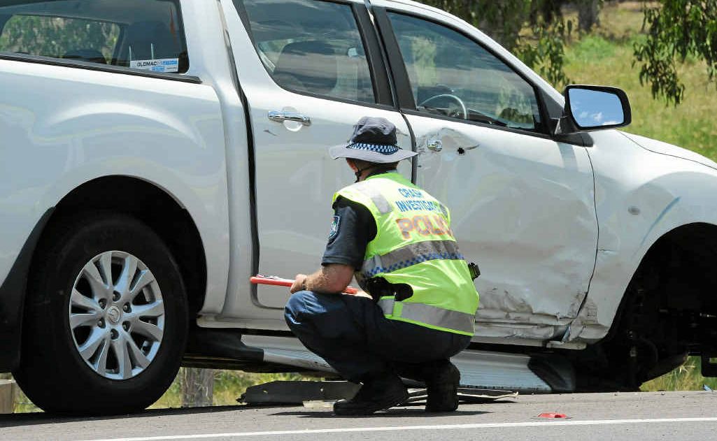 An officer from the Forensic Crash unit inspects a vehicle involved in the incident. An officer from the Forensic Crash unit inspects a vehicle involved in the incident.