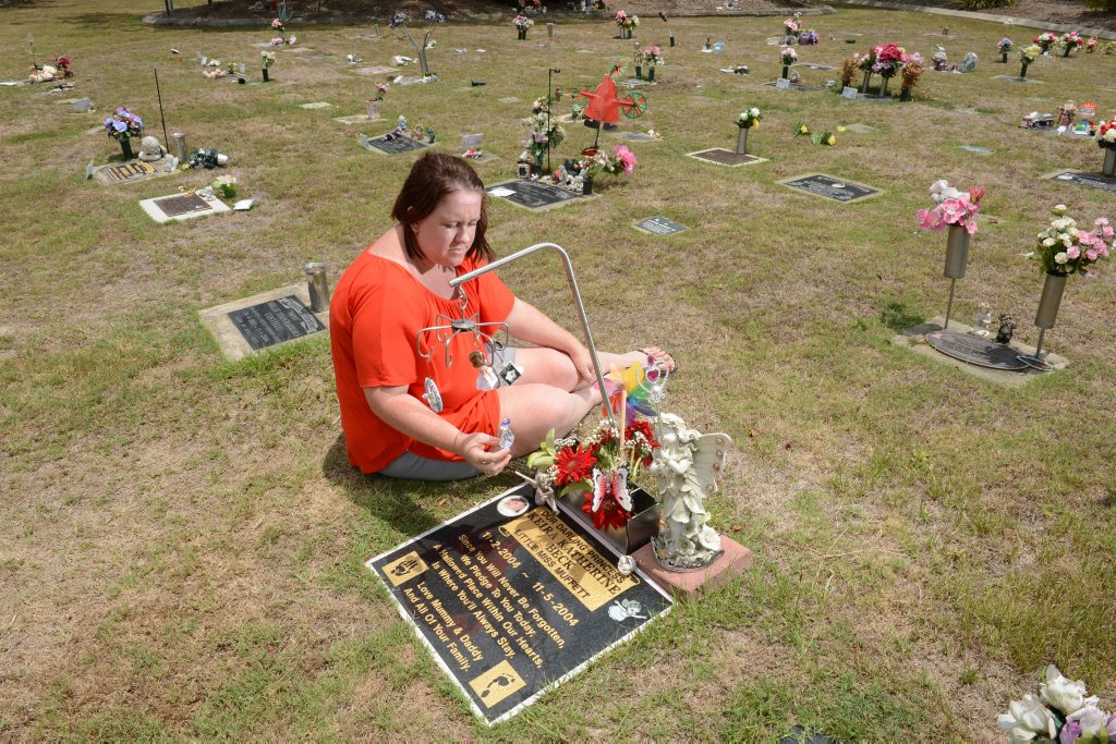 Mary Beck at her daughter's grave at Warrill Park Cemetery. Mary is upset that the cemetery management have placed letters on graves asking for all trinkets to be removed from graves. Mary Beck at her daughter's grave at Warrill Park Cemetery. Mary is upset that the cemetery management have placed letters on graves asking for all trinkets to be removed from graves.