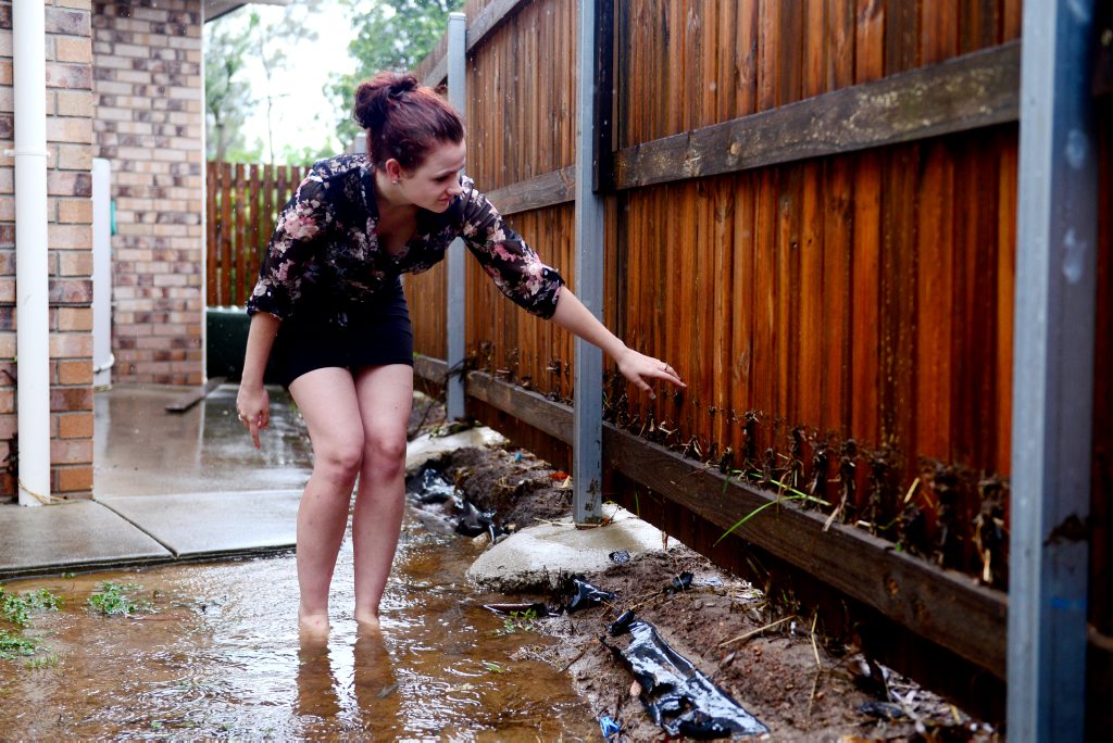 Heavy rain fall in Gladstone created flood waters and blocked drains on Marten Street. Amy Reis is a little dissapointed now that their may be damage to her new first car. Photo Brenda Strong / The Observer Heavy rain fall in Gladstone created flood waters and blocked drains on Marten Street. Amy Reis is a little dissapointed now that their may be damage to her new first car. Photo Brenda Strong / The Observer