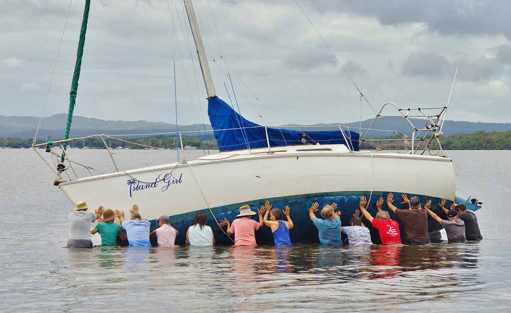Tin Can Bay locals band together to refloat a stricken yacht which, earlier yesterday, was left high and dry in the bay. Tin Can Bay locals band together to refloat a stricken yacht which, earlier yesterday, was left high and dry in the bay.