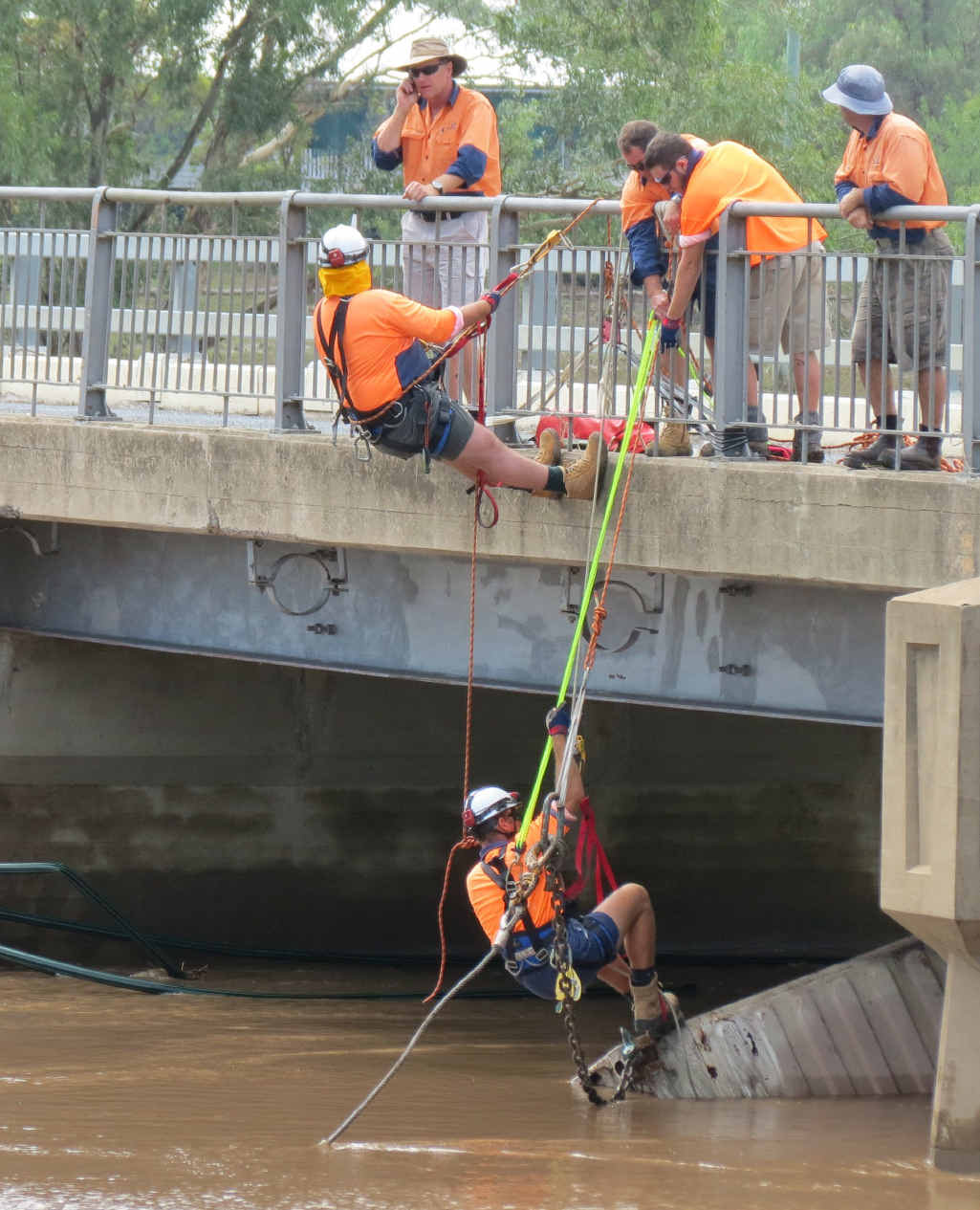 Southern Downs Council staff and the SES worked to remove a shipping container wedged under the McCahon Bridge yesterday.