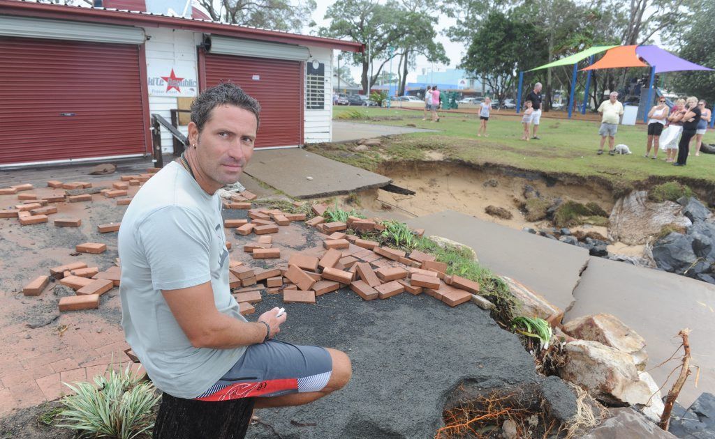 Enzo's cafe owner Enzo Andreuzzi next to the damaged outdoor area and broken ramp in front of the cafe at Scarness. Enzo's cafe owner Enzo Andreuzzi next to the damaged outdoor area and broken ramp in front of the cafe at Scarness.