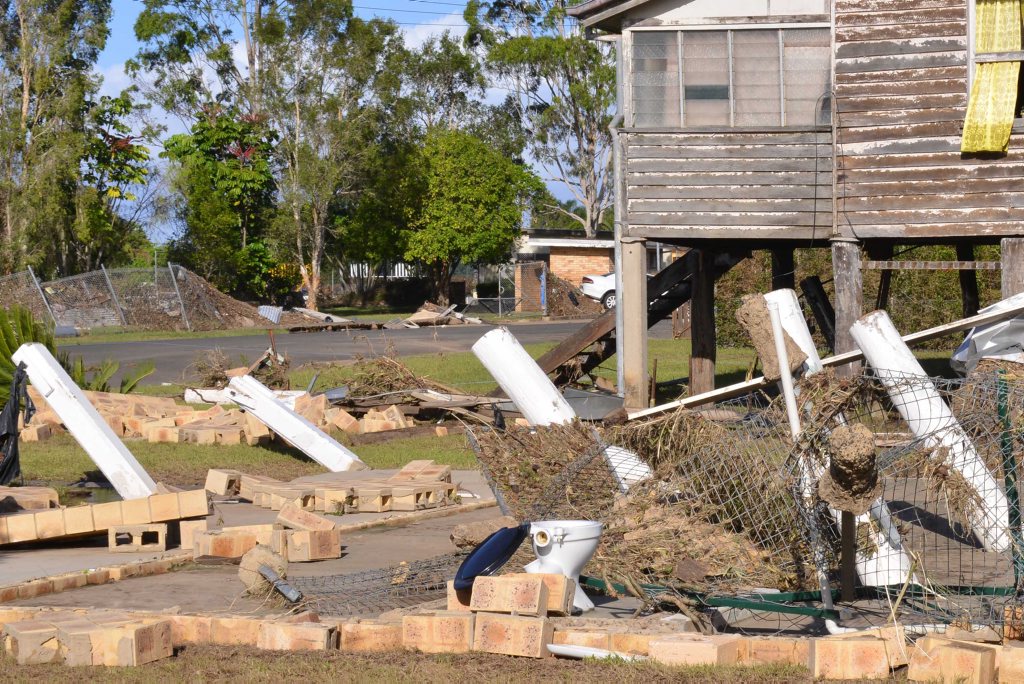 FLOOD DAMAGE: The flood water swept one home away whilst its neighbour remains on Thornhill st North Bundaberg. Photo: Scottie Simmonds / NewsMail FLOOD DAMAGE: The flood water swept one home away whilst its neighbour remains on Thornhill st North Bundaberg. Photo: Scottie Simmonds / NewsMail