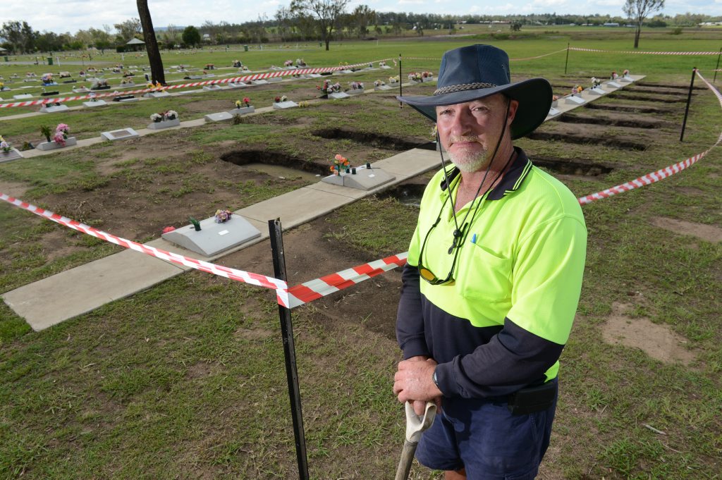 Grounds supervisor of Warrill Park Cemetery, Rick Nice, at some of the graves that sunk during the 2013 January flood. Grounds supervisor of Warrill Park Cemetery, Rick Nice, at some of the graves that sunk during the 2013 January flood.