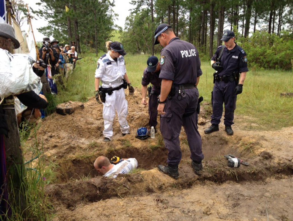 Police at the Doubtful Creek set to extracting a dug-in protester. Police at the Doubtful Creek set to extracting a dug-in protester.