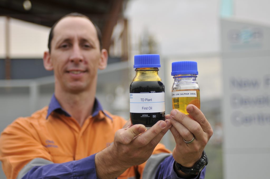 QER general manager Chris Anderson showcases the company's first bottle of oil from a demonstration plant near Fishermans Lane, Gladstone, in 2011. QER general manager Chris Anderson showcases the company's first bottle of oil from a demonstration plant near Fishermans Lane, Gladstone, in 2011.