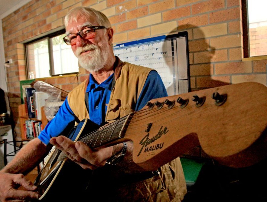 Men's Shed music man Michael Newell with the guitar owned by Johnny Cash. 