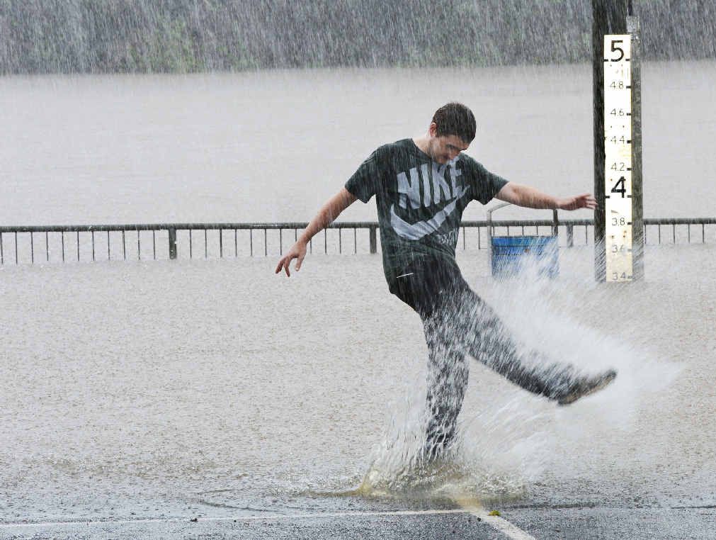 MORE THAN A SPLASH: Lismore man Jake Smith checking out the height of the Wilsons River in the car park behind Lismore Transit Centre, off Magellan St, yesterday. MORE THAN A SPLASH: Lismore man Jake Smith checking out the height of the Wilsons River in the car park behind Lismore Transit Centre, off Magellan St, yesterday.