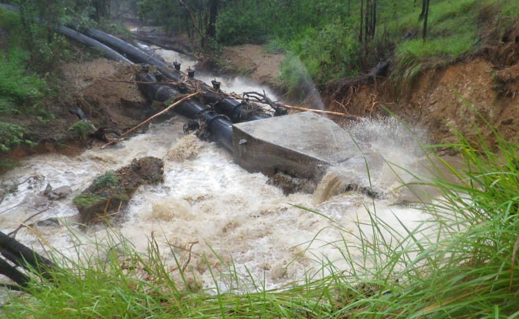 The Nymboida River under full flood bursts the pipeline bulkheads through a kilometre of mountainside tunnel, gouging a huge chasm through the Nymboida property of Rod and Jenny Zietsch. The Nymboida River under full flood bursts the pipeline bulkheads through a kilometre of mountainside tunnel, gouging a huge chasm through the Nymboida property of Rod and Jenny Zietsch.