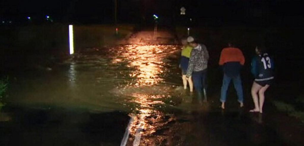 Laidley residents check levels as water flowed over streets yesterday. Laidley residents check levels as water flowed over streets yesterday.