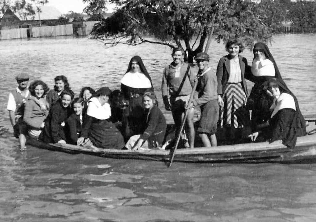 Out and about during a 1950s flood in Cowper. Out and about during a 1950s flood in Cowper.