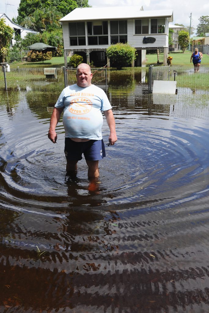 Funny smelling and a little too brown. Toogoom Esplanade residents struggle with dirty floodwater pooled in their front yards. Colin Demaine wades out of his newly rented property. Funny smelling and a little too brown. Toogoom Esplanade residents struggle with dirty floodwater pooled in their front yards. Colin Demaine wades out of his newly rented property.