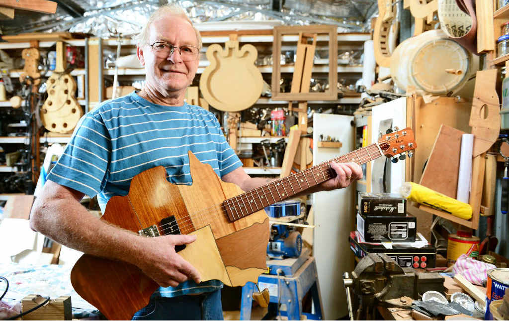 STATE-OF-THE-ART: Woodworker and guitar maker Ray Mole of Collingwood Park with his map of Australia guitar. STATE-OF-THE-ART: Woodworker and guitar maker Ray Mole of Collingwood Park with his map of Australia guitar.