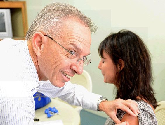 Dr Rod Day gives a flu shot to The Gympie Times’ deputy editor Shelley Strachan.