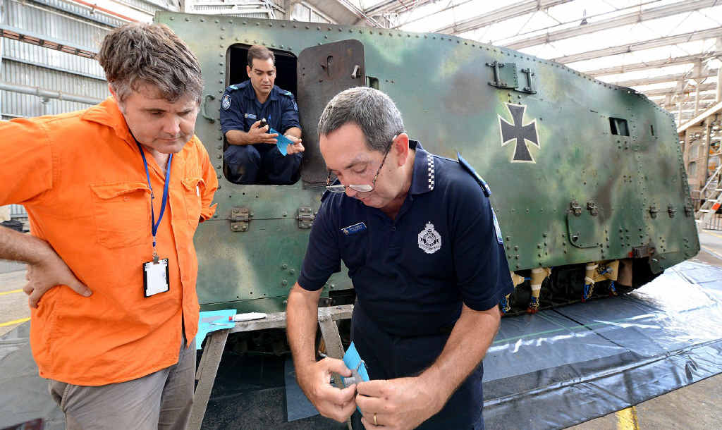 COLD CASE: Police Ballistics Services officer Alan Piper (right) shows a mould taken from the First World War German tank Mephisto to Queensland Museum senior curator Michael Westaway. Police officer Ashley Huth is in the tank with another mould. COLD CASE: Police Ballistics Services officer Alan Piper (right) shows a mould taken from the First World War German tank Mephisto to Queensland Museum senior curator Michael Westaway. Police officer Ashley Huth is in the tank with another mould.