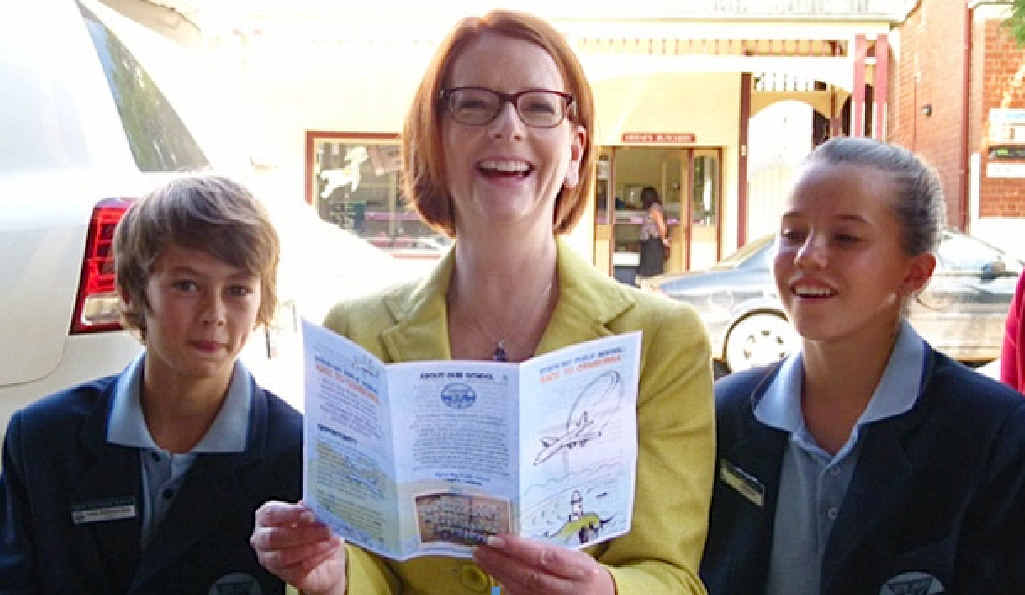 OUR SCHOOL: PM Julia Gillard reads the school brochure to Byron Bay Public School’s captains Louis Robinson-Gale and Tia Gotterson. OUR SCHOOL: PM Julia Gillard reads the school brochure to Byron Bay Public School’s captains Louis Robinson-Gale and Tia Gotterson.