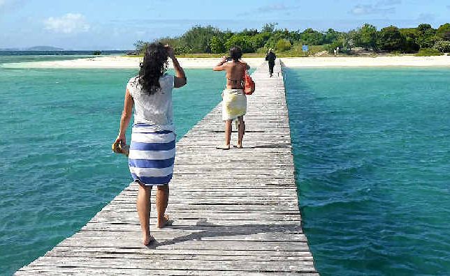 Tourists take a stroll along a pier at the uninhabited Signal Island. Tourists take a stroll along a pier at the uninhabited Signal Island.