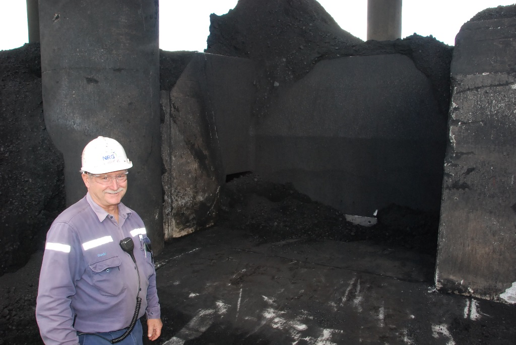 NRG Gladstone Power Station fuel plant operator Dave Brown checks out the recently exposed area of the slot bunker. The area hasn't been seen for decades, but is now visible because coal stockpiles are low after wet weather earlier this year. NRG Gladstone Power Station fuel plant operator Dave Brown checks out the recently exposed area of the slot bunker. The area hasn't been seen for decades, but is now visible because coal stockpiles are low after wet weather earlier this year.