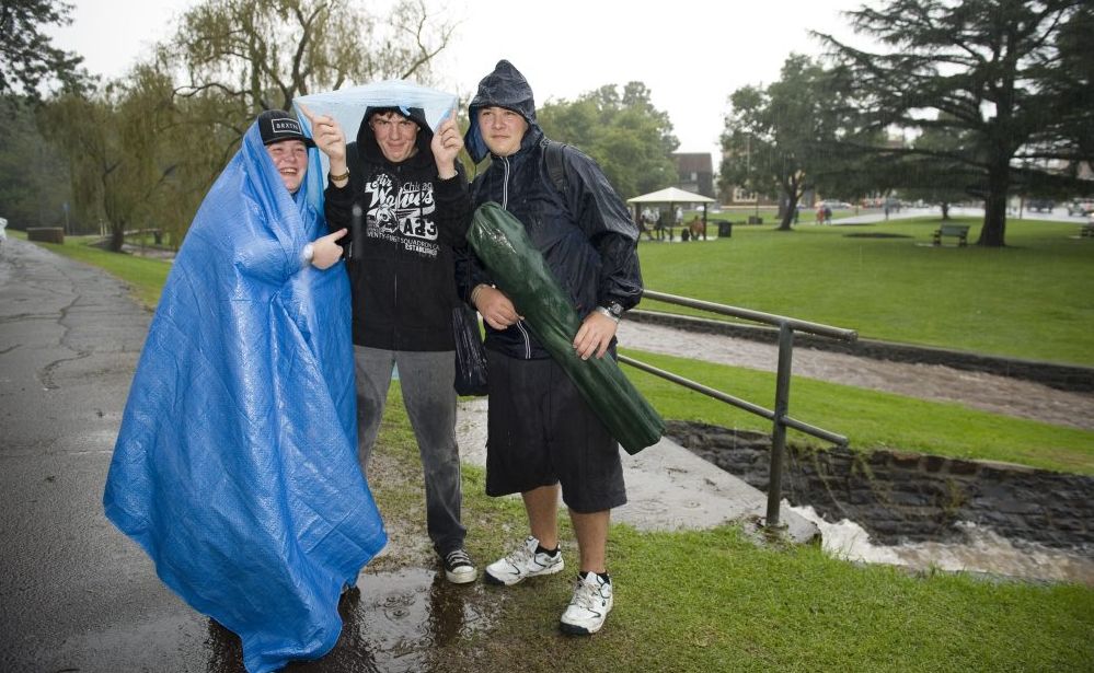 Rain fails to dampen the spirits of (from left) Samantha Moorhouse, William Laverty and Darcy Moorhouse, all of Toowoomba. Rain fails to dampen the spirits of (from left) Samantha Moorhouse, William Laverty and Darcy Moorhouse, all of Toowoomba.