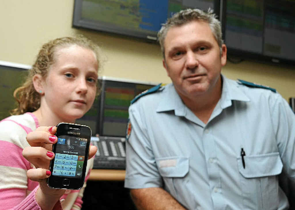 THE RIGHT CALL: Claudia Stevens, 10, shows the importance of kids being able to use the 000 service effectively, pictured with her father Mark Stevens, the Sunshine Coast Ambulance Operations Centre supervisor.