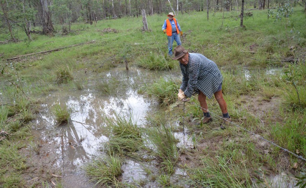 HELPING HAND: Mundubbera BlazeAid camp volunteer Ron Anderson(back) helps farmer Peter Larner with fences on his property. Photo Contributed HELPING HAND: Mundubbera BlazeAid camp volunteer Ron Anderson(back) helps farmer Peter Larner with fences on his property. Photo Contributed